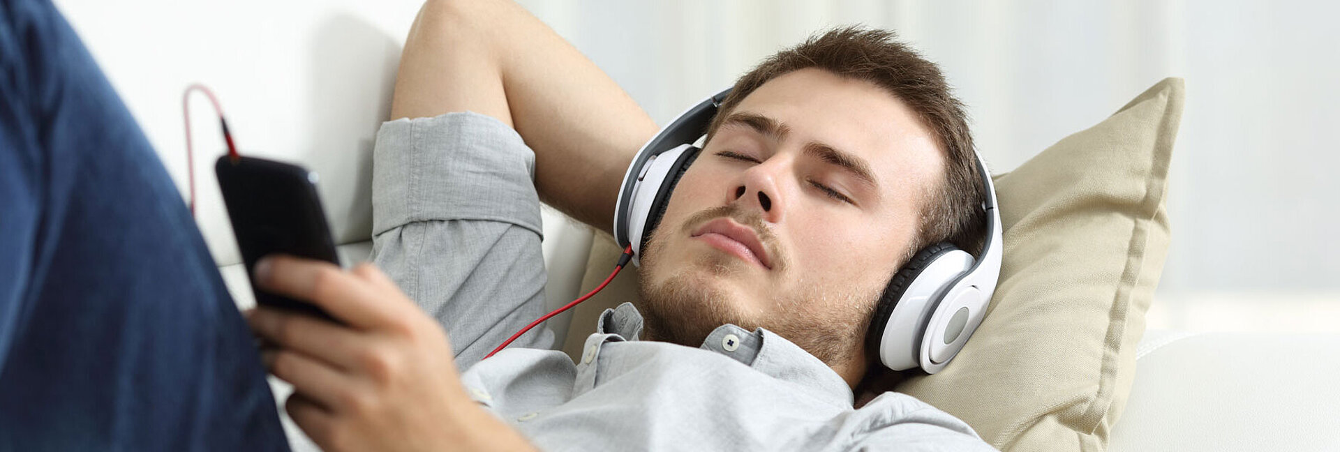 ORS - radio streaming young man listening to music with smartphone