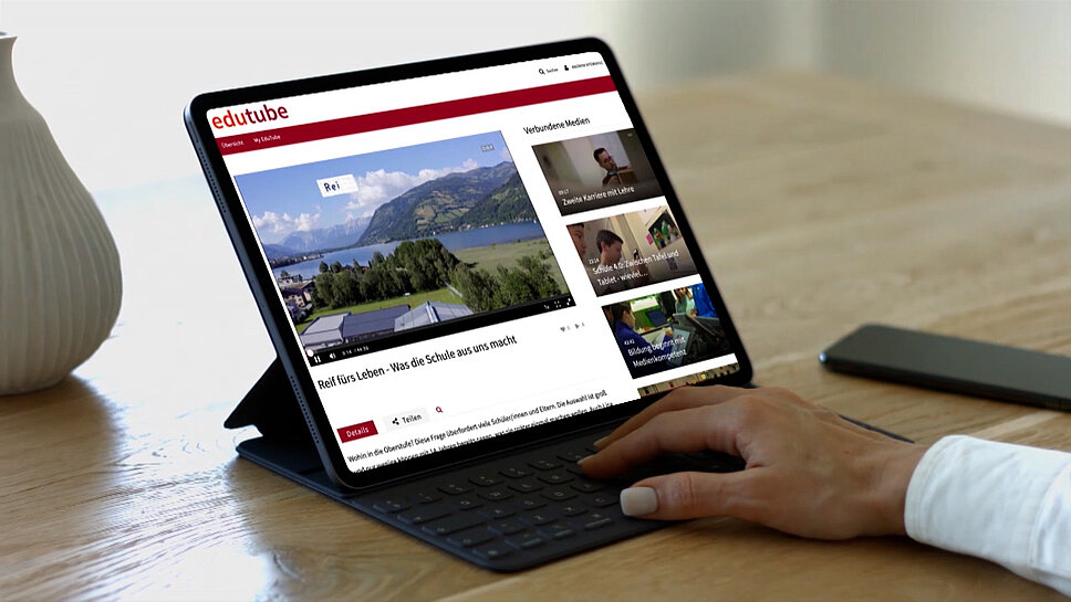 edutube - the homeschooling video platform Tablet with hand