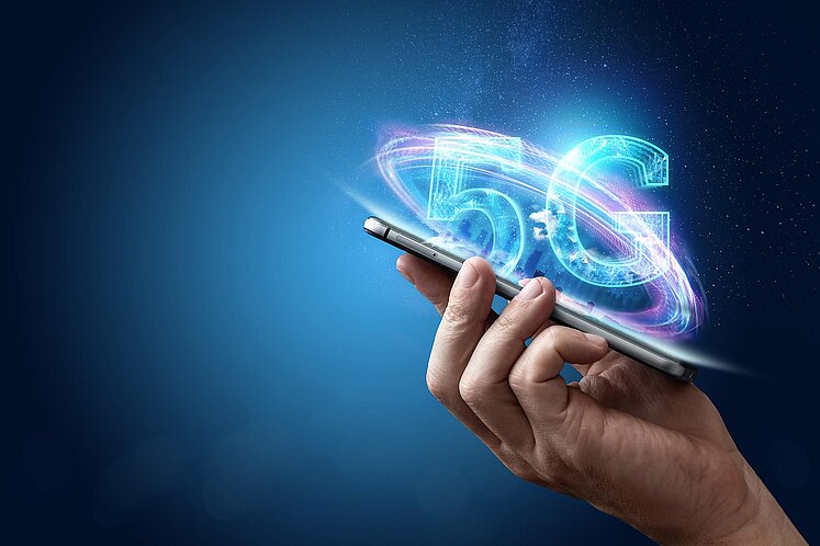 Benefits of 5G Broadcast Hand with Smartphone and 5G Logo