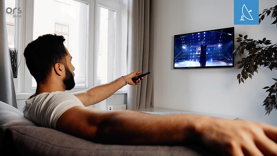 Man watching TV on sofa